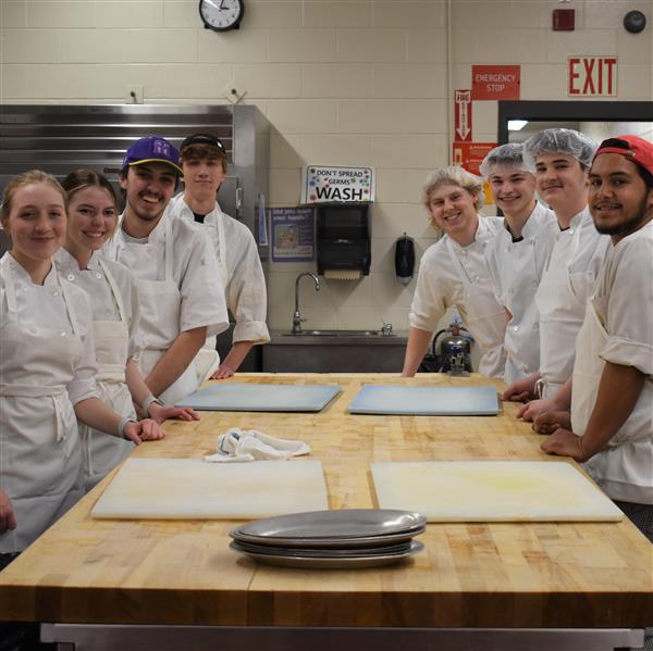  Eight students in a professional kitchen